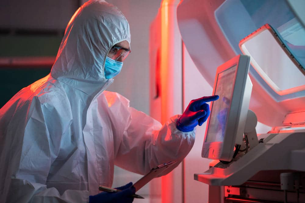 Doctor performing medical research in lab red light